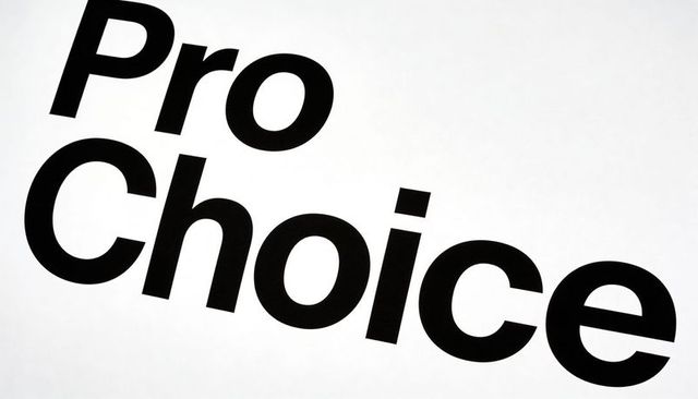 Bold pro choice lettering on tilted white poster for reproductive rights protest