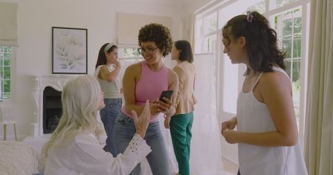 Joyful Bridesmaids Preparing Together on Wedding Day Morning