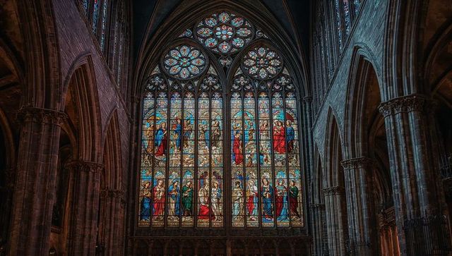 Intricate stained glass window in majestic gothic cathedral