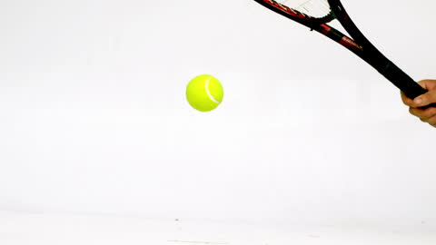 Close-up of Tennis Player Hitting Ball in Motion