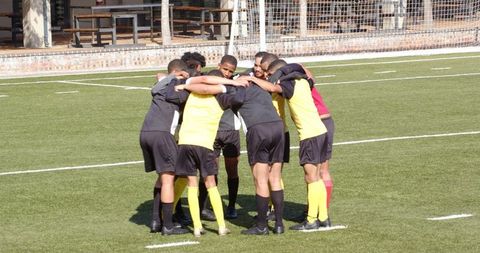 Soccer Team Unites in Huddle for Pre-Match Motivation and Strategy