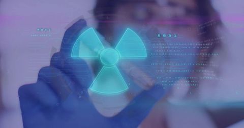 Scientist analyzing data with digital nuclear energy symbol overlay