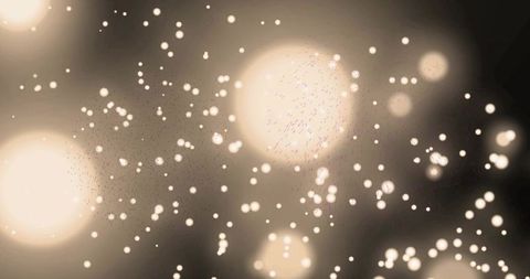 Glowing sepia bokeh orbs floating over soft ambient dust and light