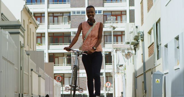 Woman walking with bicycle in the city on a sunny day. 4k