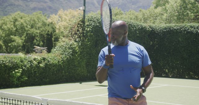 Mature Man Playing Tennis on Outdoor Court - Download Free Stock Images Pikwizard.com