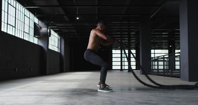 Shirtless Man Training with Battle Ropes in Gym - Download Free Stock Images Pikwizard.com