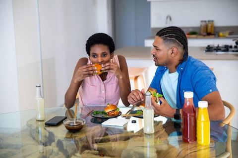Couple Enjoying Burgers and Salads at Modern Dining Table