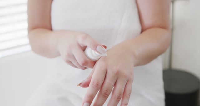 Woman Applying Lotion on Hand Indoor Relaxation - Download Free Stock Images Pikwizard.com