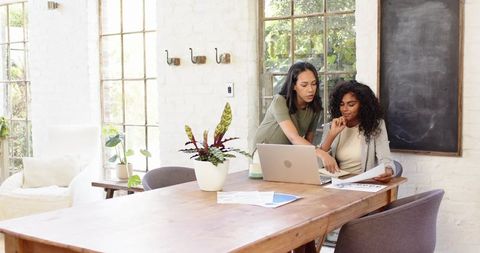 Diverse Team Analyzing Business Documents in Modern Office