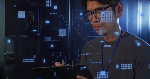 Korean IT Engineer Monitoring Servers with Tablet and Holographic Interface in Datacenter