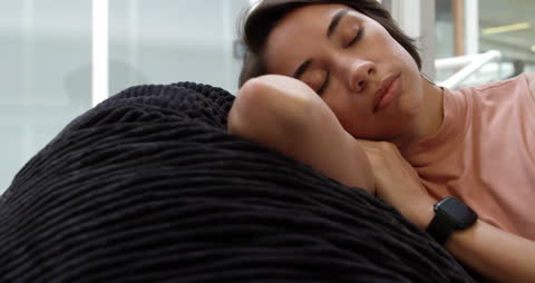 Young Woman Sleeping Peacefully on Comfortable Couch