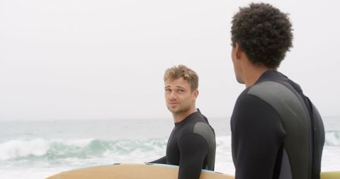 Surfers Conversing by Ocean's Edge