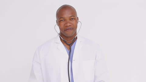Doctor with Stethoscope Smiling in White Clinic Suit
