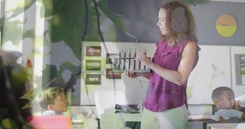 Diverse teacher explains science with live plants in classroom