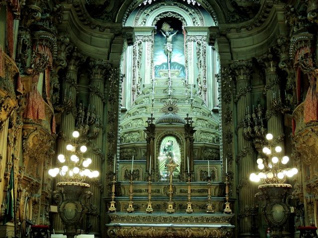 This image displays an intricate Baroque cathedral interior highlighting the ornate altar, magnificent architectural details, and exquisite lighting. Useful for illustrating religious themes, architectural designs, historical studies, cultural heritage, art history, and interior decoration ideas.