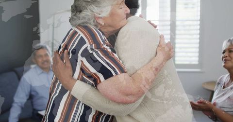 Hugging Senior Women Celebrating Reunion in Sunlit Living Room Family Gathering