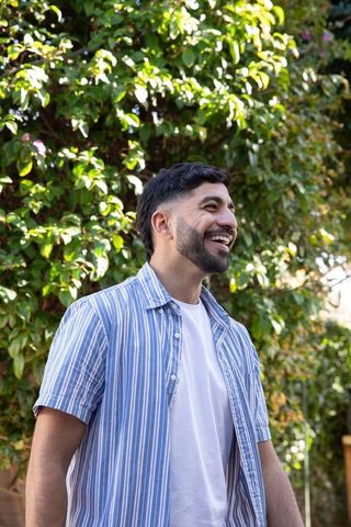 Happy Man Enjoying Relaxing Moment Outdoors in Greenery