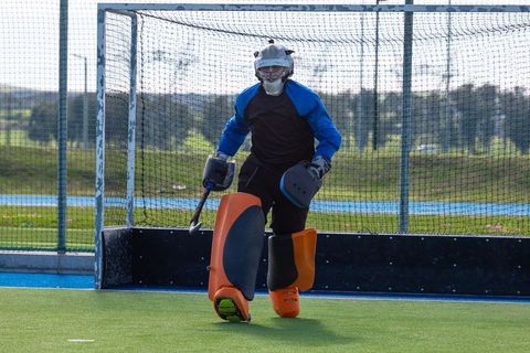 Hockey Goalkeeper on Field Wearing Full Protective Gear