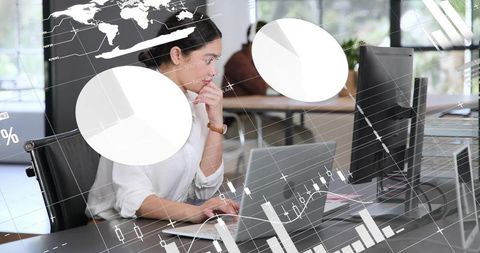Businesswoman analyzing financial charts on laptop with analytics overlay in open-plan office