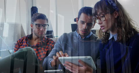 Diverse Team Analyzing Data with Digital Tablet in Modern Office