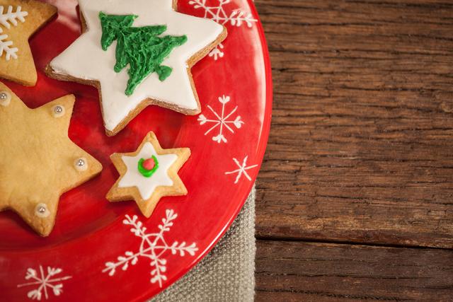 Christmas cookies on a red plate with snowflake designs, perfect for holiday-themed projects, festive advertisements, or social media posts celebrating the Christmas season.