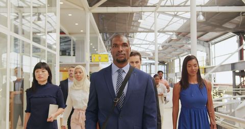 Diverse Business Delegates Walking in Modern Foyer