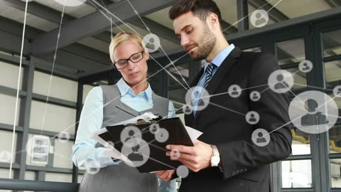 Caucasian Professionals Analyzing Digital Network Data in Office