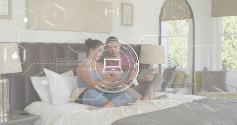 Couple Using Smartphone and Tablet on King Bed with Futuristic HUD Overlay for Smart Home