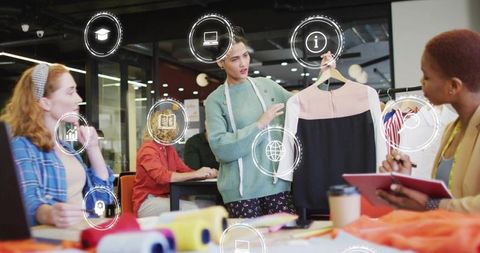Fashion design team evaluating dress prototype with ar overlays in collaborative studio
