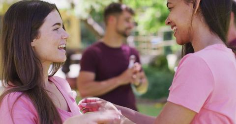 Women Bonding, Supporting Breast Cancer Awareness with Pink Ribbon