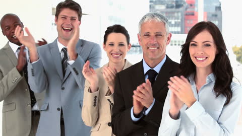Successful Business Team Clapping in Modern Office Setting
