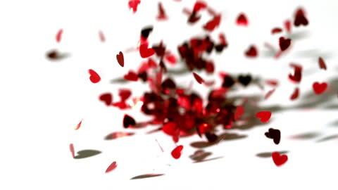 Red Heart Confetti Falling on White Background