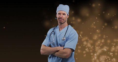 Middle aged male doctor in scrubs with confident smile