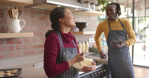 Happy Couple Having Fun Baking Together at Home