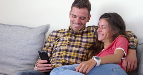 Happy Couple Relaxing at Home Sharing Smartphone - Download Free Stock Images Pikwizard.com