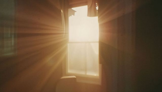 Sunlit Window Casting Warm Light into Minimalist Room