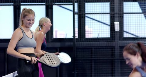 Female Friends Playing Padel Showing Enjoyment and Team Spirit