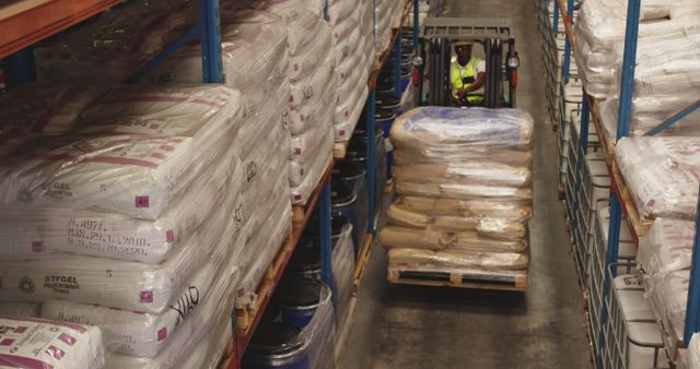 Warehouse Worker Operating Forklift Among Stacked Goods - Download Free Stock Images Pikwizard.com