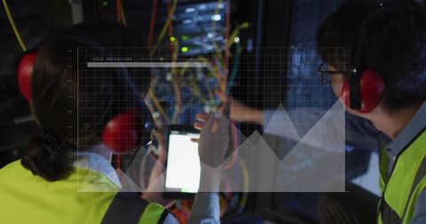 It technicians monitoring server data and analyzing graphs