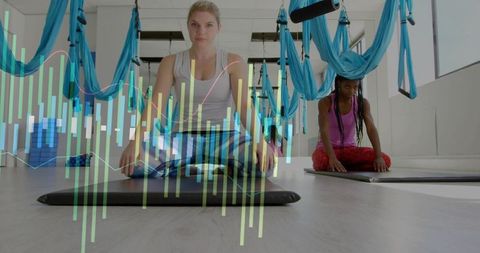 Woman Kneeling with Fitness Data and Aerial Hammocks in Studio