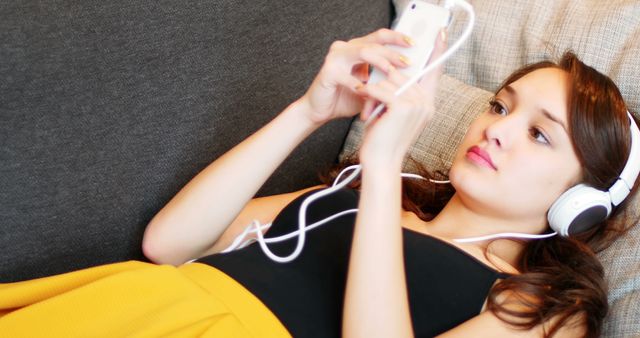 Young Woman Listening to Music on Smartphone at Home - Download Free Stock Images Pikwizard.com