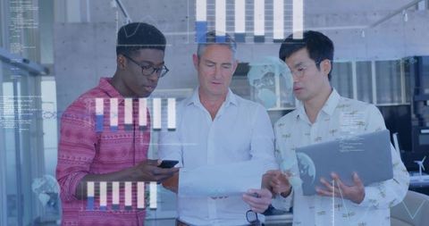 Diverse team collaborating on data reports and laptop with digital analytics overlay