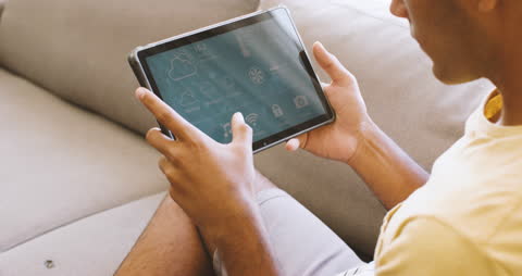 Man Engaging with Smart Home Tablet Screen