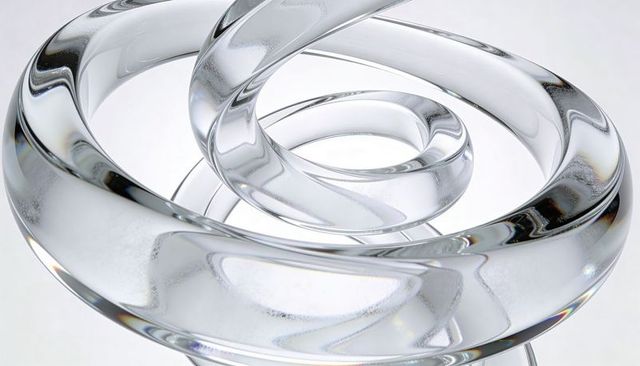 Crystal glass spiral sculpture with toroidal refractive rings and iridescent highlights