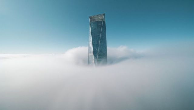 Towering Skyscraper Emerges Through Ocean of Clouds