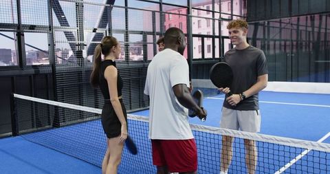 Diverse Friends Enjoying Padel on Blue Indoor Court