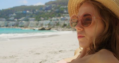 Caucasian Woman Relaxing at Idyllic Beach in Sun Hat - Download Free Stock Images Pikwizard.com