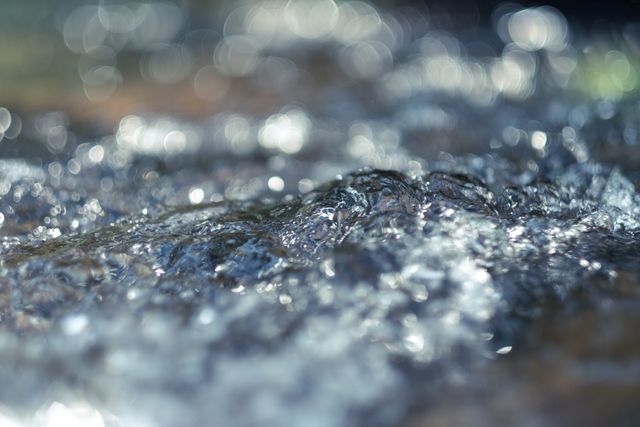 Close-Up of Flowing Water with Beautiful Bokeh Effect - Download Free Stock Photos Pikwizard.com