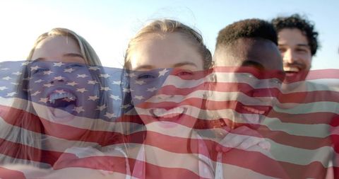 Friends celebrating fourth of july at beach, smiling and posing with american flag overlay