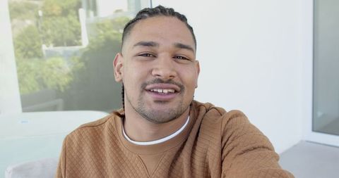 Smiling Man Taking Selfie on Modern Balcony